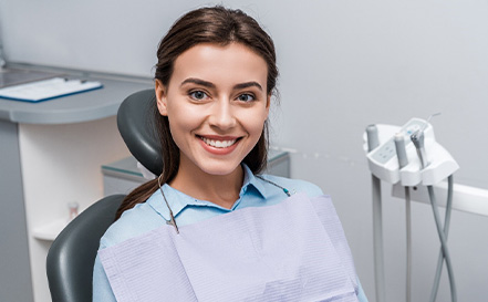 Female dental patient smiling after getting dental implants in San Antonio, TX