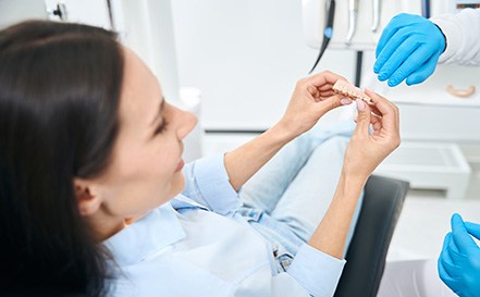 Dentist showing dental bridge options to patient