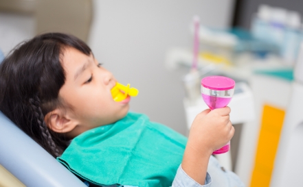 Child being fitted for athletic mouthguard