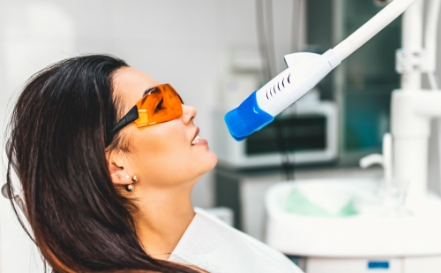 Dental patient receiving teeth whitening treatment