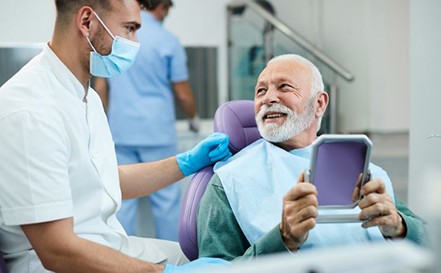 Senior man speaking with his dentist