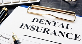 Dental insurance form on a crowded desk