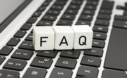 Blocks spelling FAQ sitting on a keyboard