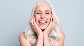 A woman happy about the benefits of dental implants in San Antonio