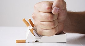 Hand crushing cigarettes