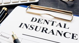 Dental insurance paperwork on black wooden desk 