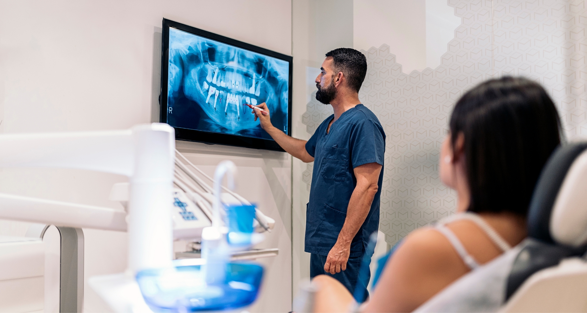 Dentist and patient looking at digital dental x rays