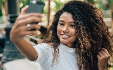 Young woman taking selfie on her cell phone