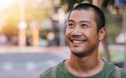 Man smiling on a city street