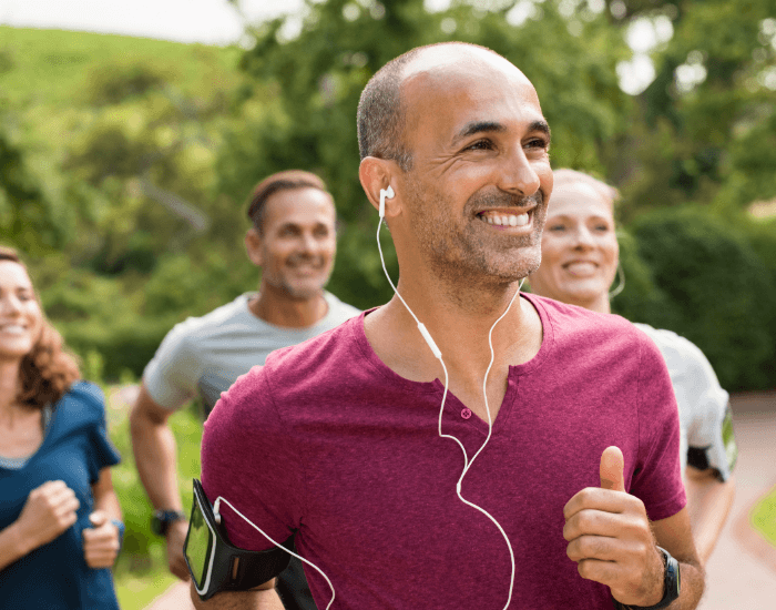 man smiling and jogging