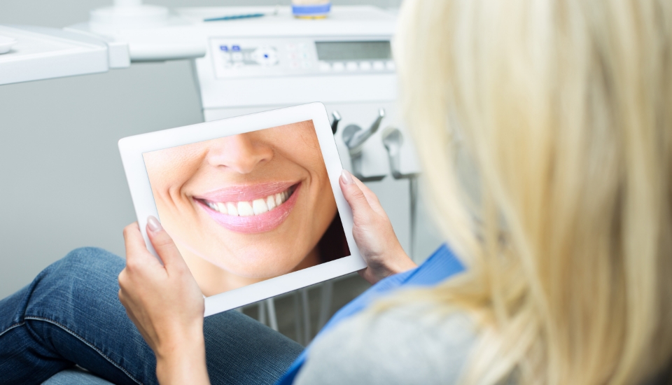 Woman looking at dental restoration design during restorative dentistry visit