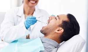 dentist completing a dental checkup on a patient
